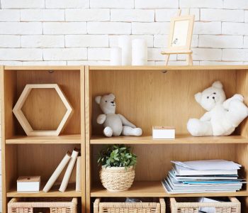 Wooden shelf sgainst white brick wall in empty room