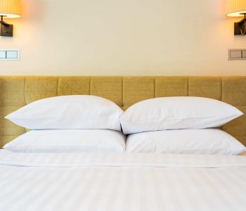 White pillow and blanket with light lamp decoration interior of bedroom